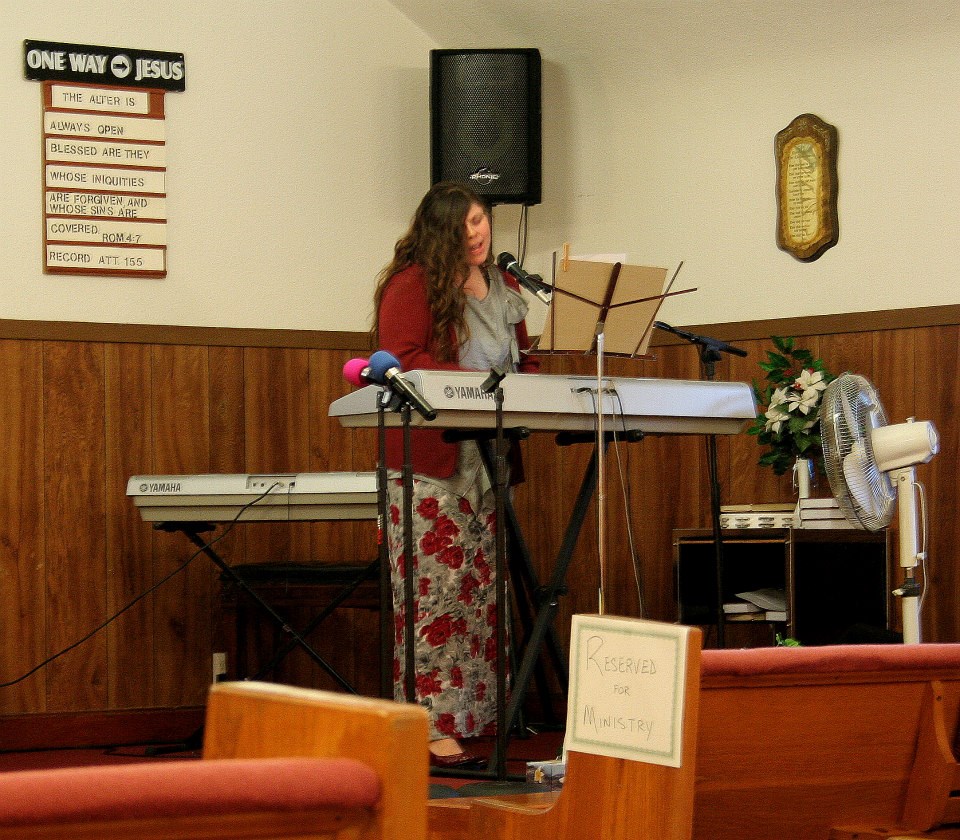 Worship leader playing keyboard during a service at the chapel